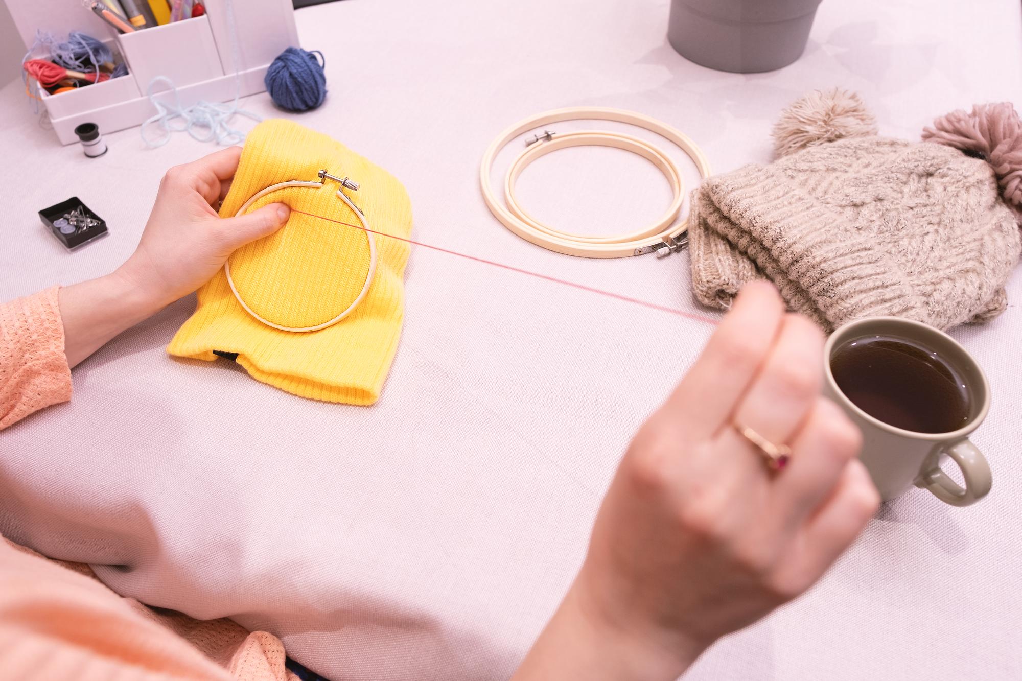 Artist arranging threads at table